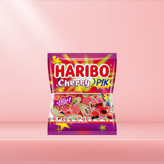 Sachet de Haribo Cherry Pik, bonbons acidulés en forme de cerises, sur fond rose.